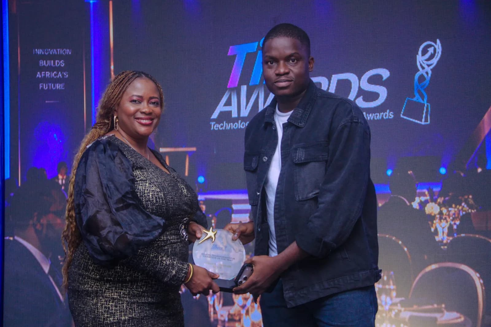 Ayodeji Stephen Saliu receiving the Digital Transformation Champion of the Year award on stage at the TIL Awards